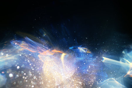 Background of gold and blue lens flare lights. Abstract image