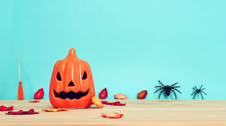 Halloween background pumpkin on wooden table and autumn leavesの写真素材