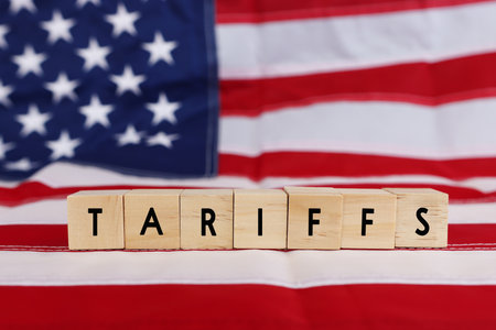 United states flag and cubes with the text tariffsの写真素材