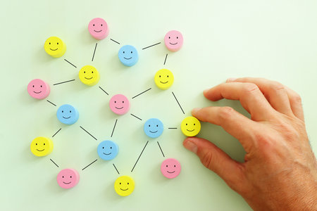 Concept image of satisfaction level. wooden cubes with happy emotionsの写真素材