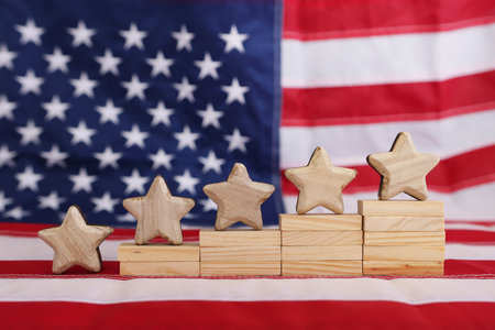 Concept image of five stars and American flag background. Idea of quality and customer satisfactionの写真素材