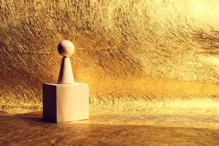 Concept of leadership and forwarding ahead. Wooden figure on top of cube