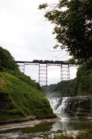 Modern freight train crossing a 125 year old railroad bridg over the Genesee River Gorgeの写真素材