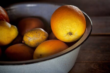 Oranges and other fruit in a porcelain covered steel bowl at Fort Christmas Historical Park, Christmas, FL.の写真素材