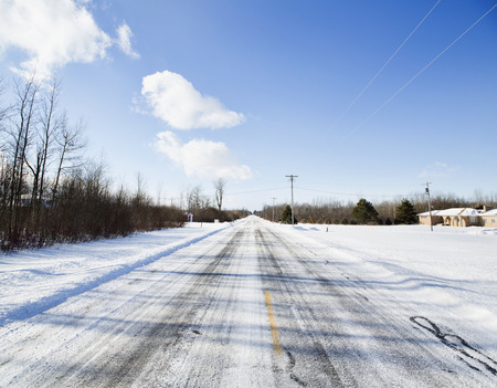 Deserted snow-covered road outside Buffalo, New York.の写真素材