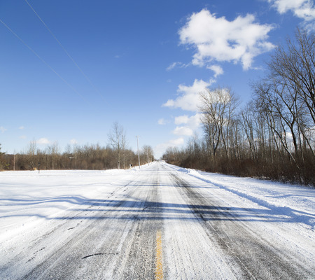 Deserted snow-covered road outside Buffalo, New York.の写真素材