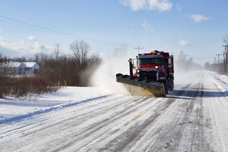 Plow clearing a rural road of snow outside Buffalo, New York.の写真素材