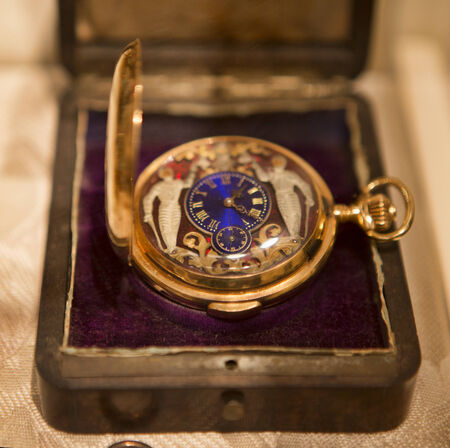 Victorian Era pocket watch in a velvet lined box on a buff colored cloth.の写真素材