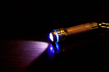 Close-up of a flashlight in the dark.の写真素材
