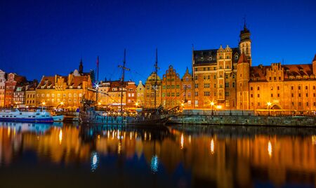 View of the old city - Historic port crane over Motlawa river in Gdansk at night, Poland