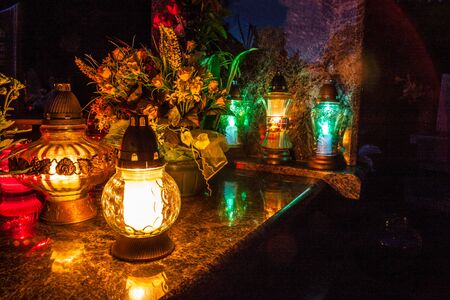 Colorful candles on the cemetery at All Saints Day, Poland