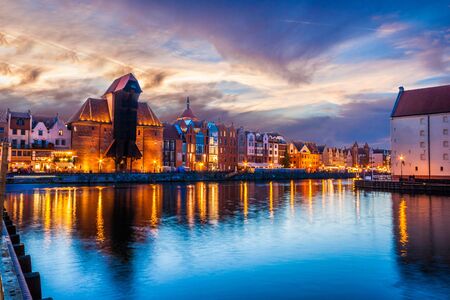 View of the old city - Historic port crane over Motlawa river in Gdansk at night, Polandの写真素材