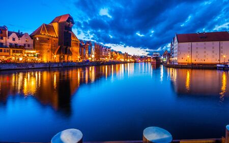 View of the old city - Historic port crane over Motlawa river in Gdansk at night, Polandの写真素材