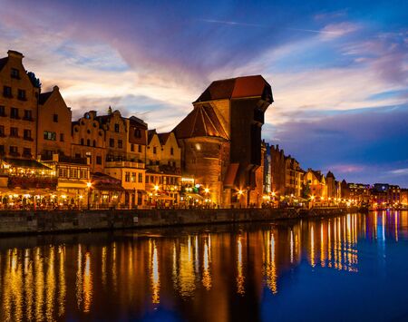 View of the old city - Historic port crane over Motlawa river in Gdansk at night, Poland