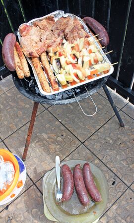 Grilling shashlik and meat on barbecue grillの写真素材