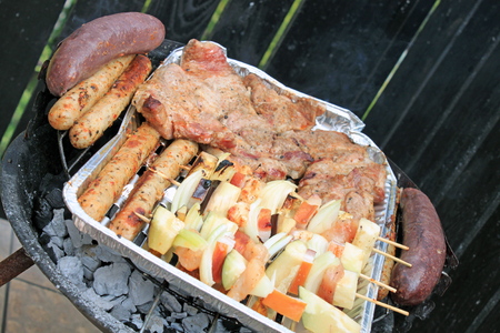 Grilling shashlik and meat on barbecue grillの写真素材