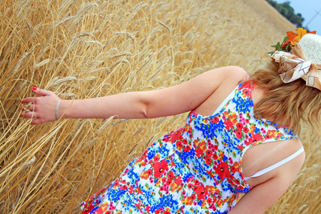 Beauty Girl Outdoors enjoying nature. Beautiful Teenage Model girl in white dress running on the Fieldの写真素材