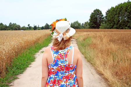 Beauty Girl Outdoors enjoying nature. Beautiful Teenage Model girl in white dress running on the Fieldの写真素材