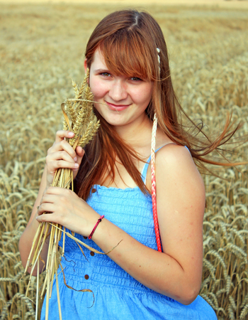 Beauty Girl Outdoors enjoying nature. Beautiful Teenage Model girl in white dress running on the Fieldの写真素材