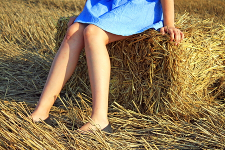 Beauty Girl Outdoors enjoying nature. Beautiful Teenage Model girl in white dress running on the Fieldの写真素材