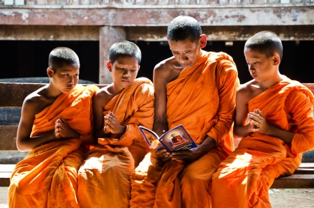 KANCHANABURI THAILAND-January 29:  An unidentified monk teaching young novice monks in temple  on January 29, 2012  at KANCHANABURI THAILAND.のeditorial素材