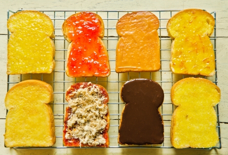 Several  toast with various topping on wood table