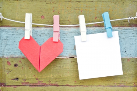 Paper heart and card hanging on the clothesline. On old wood background.Valentines day theme .の写真素材