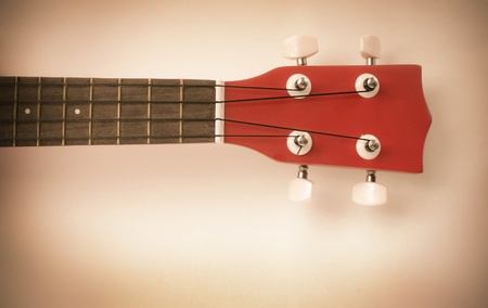 Part of red ukulele with text area Processed with vintage style 
