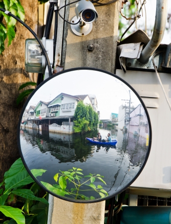 BANGKOK, THAILAND - NOV 5: Scene from defensive driving mirror with  flooded house  reflected on it during the worst flooding on November 5, 2011 in Bangkok, Thailandのeditorial素材