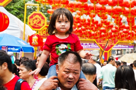 BANGKOK, THAILAND - FEBRUARY 10  Unidentified child, age about 5 years old, celebrates Chinese New Year on February 10, 2013 on Yaowarat Road in the Chinatown district of Bangkok, Thailand のeditorial素材