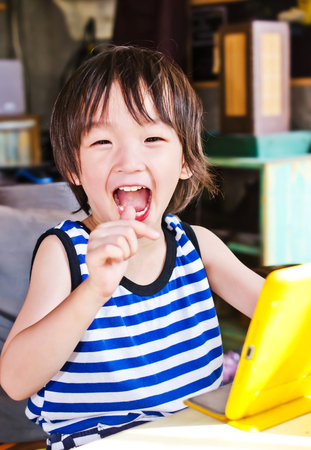 Cute asian boy play tablet computer 
