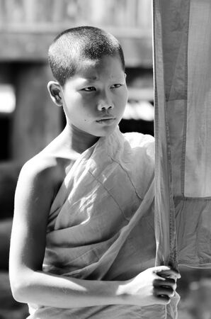 KANCHANABURI THAILAND-January 29: An unidentified  young novice monk 12 years old poses for a photo in temple on January 29, 2012 in KANCHANABURI THAILAND. Temple is the school in rural of Thailand.のeditorial素材