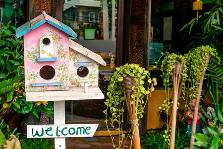 Colorful wooden bird house with welcome signの写真素材