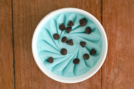 Overhead view of  homemade Mint and Chip  Italian ice cream tub on wooden backgroundの写真素材