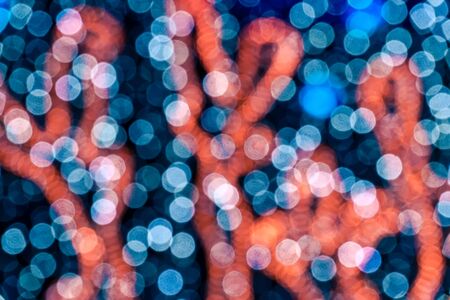 Abstract circular bokeh background against dark background for use at graphic design
