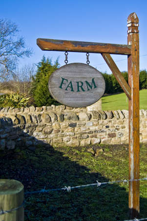 A photograph of a wooden sign for a farm.の写真素材