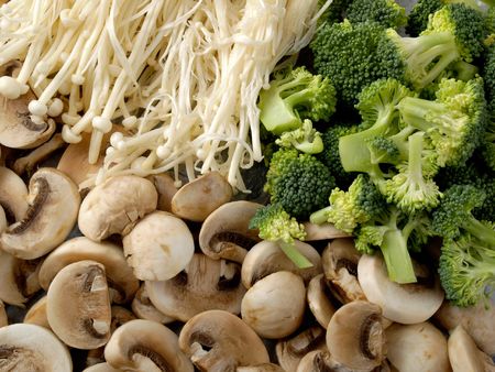 Two types of mushrooms and some broccoliの写真素材