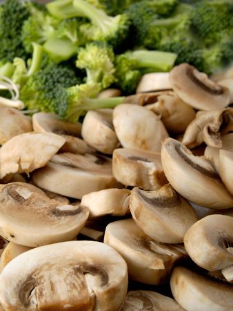 Mushrooms and broccoli on a dishの写真素材