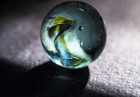 Green blue glass marble black backgroundの写真素材