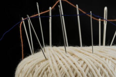 Needles on a cotton thread ball