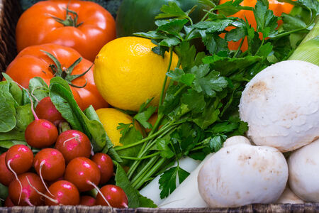 Fresh mixed vegetables in wicker trayの写真素材