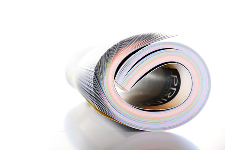 Rolled up magazine over with backgroundの写真素材