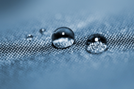 Effect with water drops on blue textileの写真素材