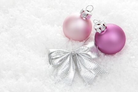 pink christmas balls with loop on artificial snowの写真素材