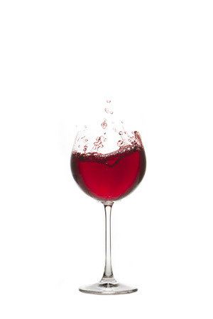 Red wine splash Glass with white backgroundの写真素材