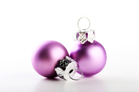 two beautiful pink christmas balls white backgroundの写真素材
