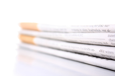 several newspaper stacked with a white backgroundの写真素材