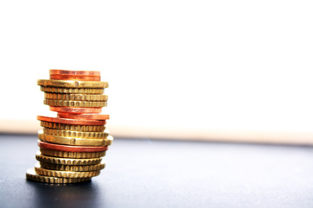 Stack of coin on ground with white backgroundの写真素材