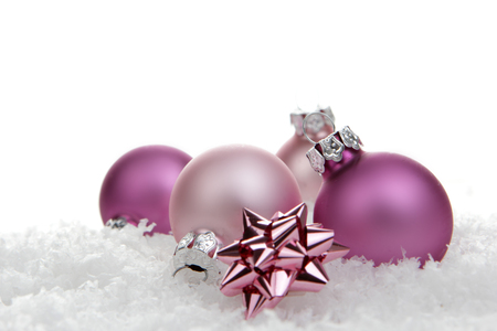 pink christmas balls with loop on artificial snowの写真素材