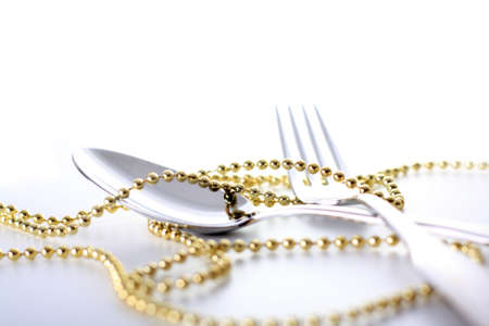 Cutlery, spoon and fork with decoration and white backgroundの写真素材